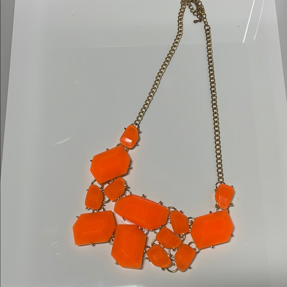 Orange costume jewelry necklace with irregular gems.